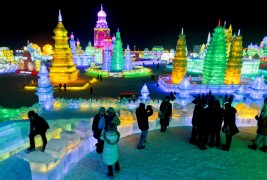 epa03049190 People visit ice sculptures at the International Harbin Ice and Snow Festival held in Harbin, China's northern Heilongjiang province, 05 January 2012. The annual three-month long festival will officially open on 06 January. The festival attracts visitors from all over China as well as a number of foreign guests who brave below zero temperatures to see colorful large ice and snow sculptures, ride horse-drawn carriages and enjoy a number of winter activities set up on the sidelines of the festival. EPA/DIEGO AZUBEL